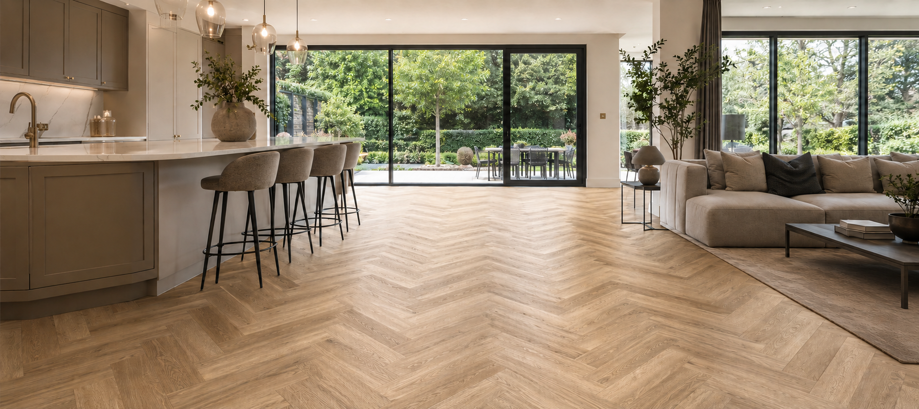 Herringbone wood-effect flooring through an open-plan kitchen and living room