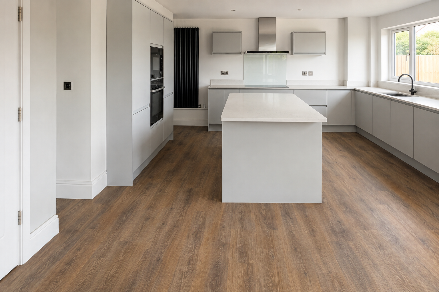 Amtico wood-effect flooring through a hallway into a modern open-plan kitchen